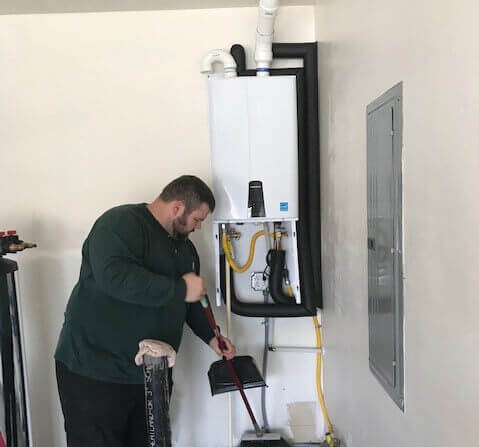 Technician working on tankless water heater